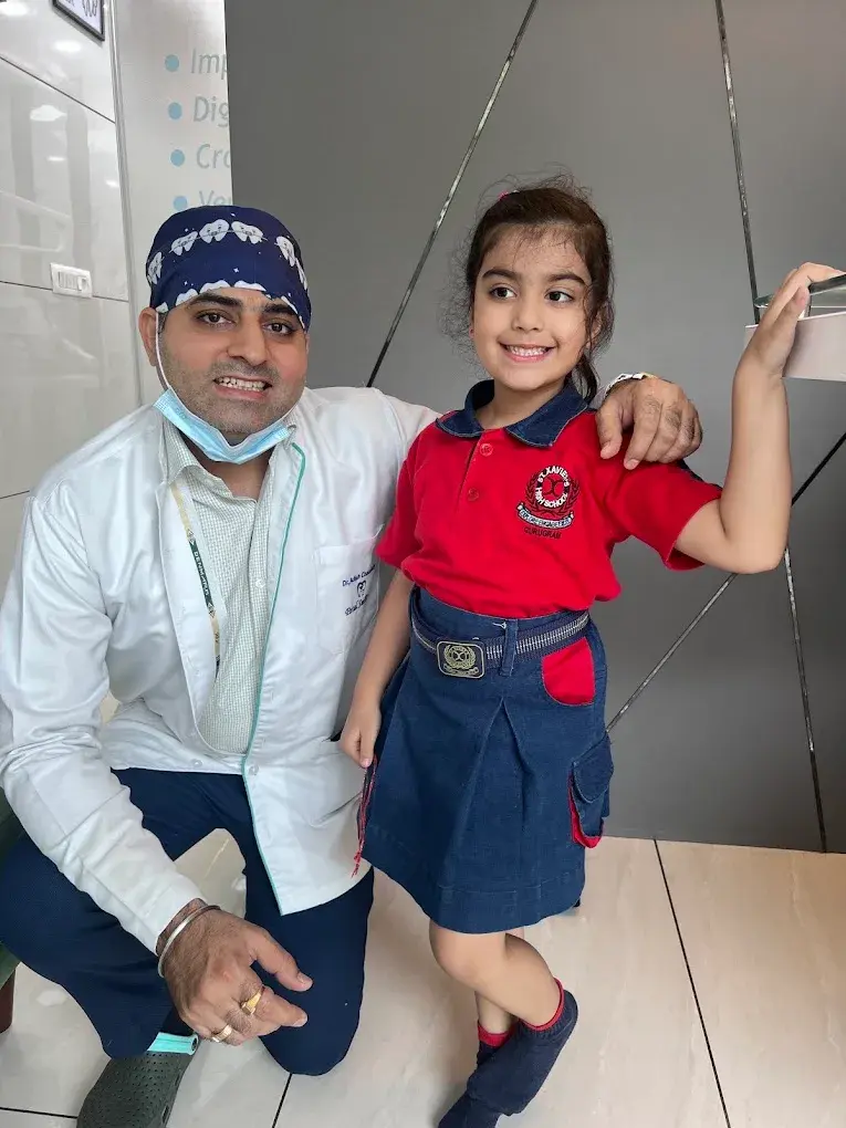 A dentist and a child posing at Petal Smiles