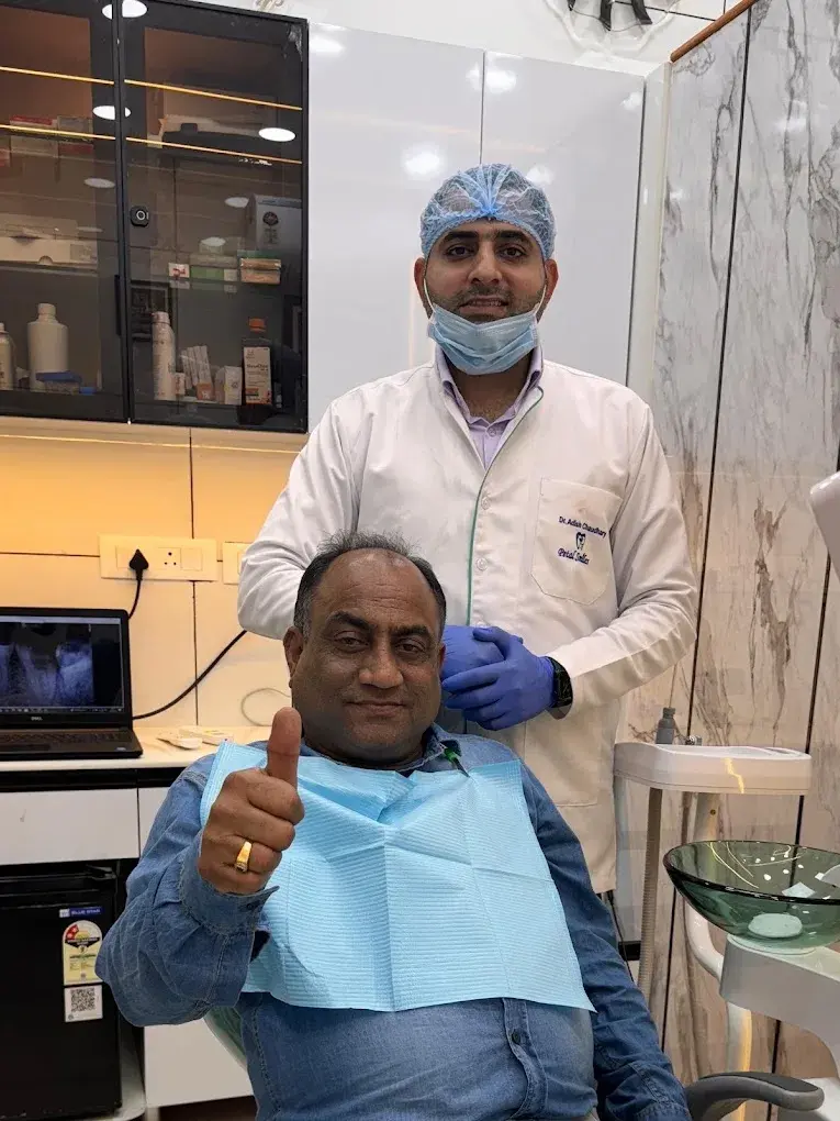 A dentist with a visitor in the Petal Smiles dental chair